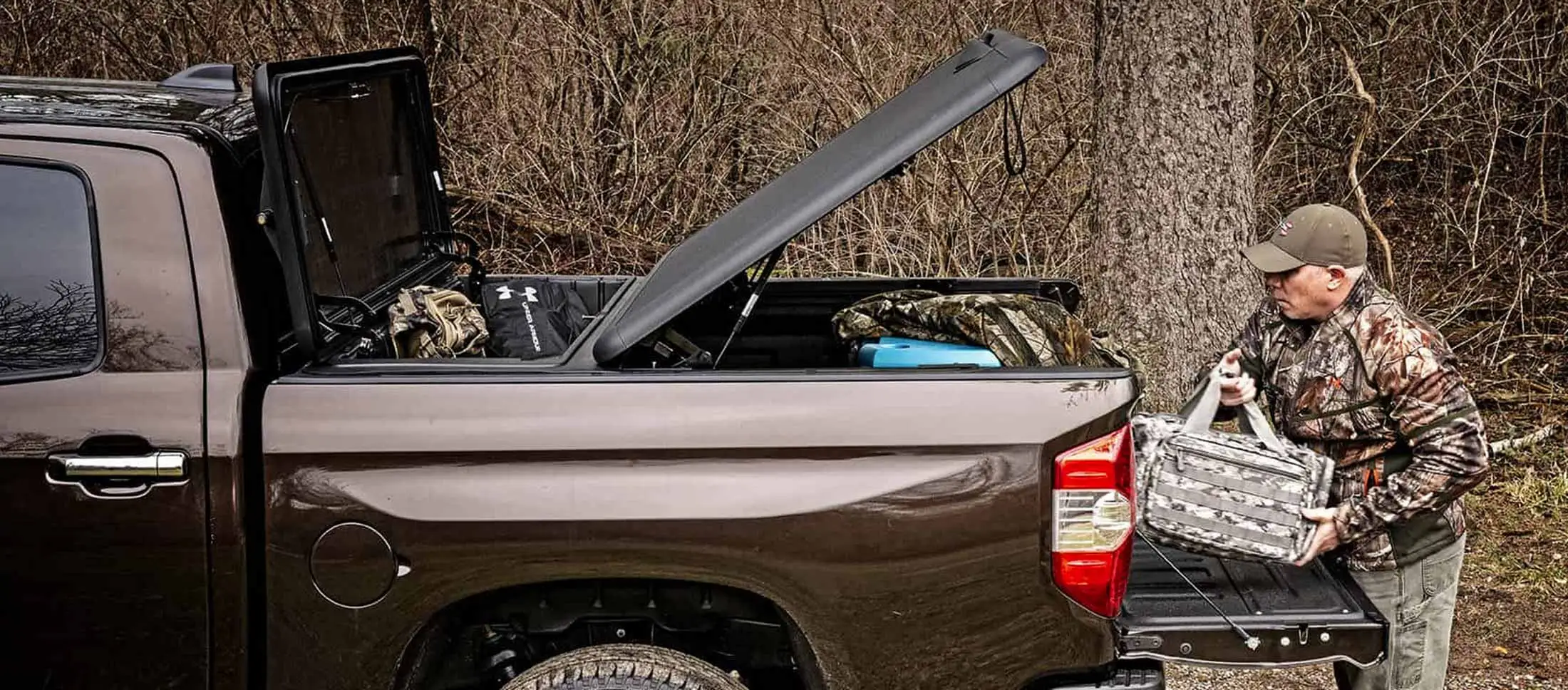 Lifestyle image fishing and hunting gear tonneau cover toolbox combo hard one piece Stowe Cargo Systems